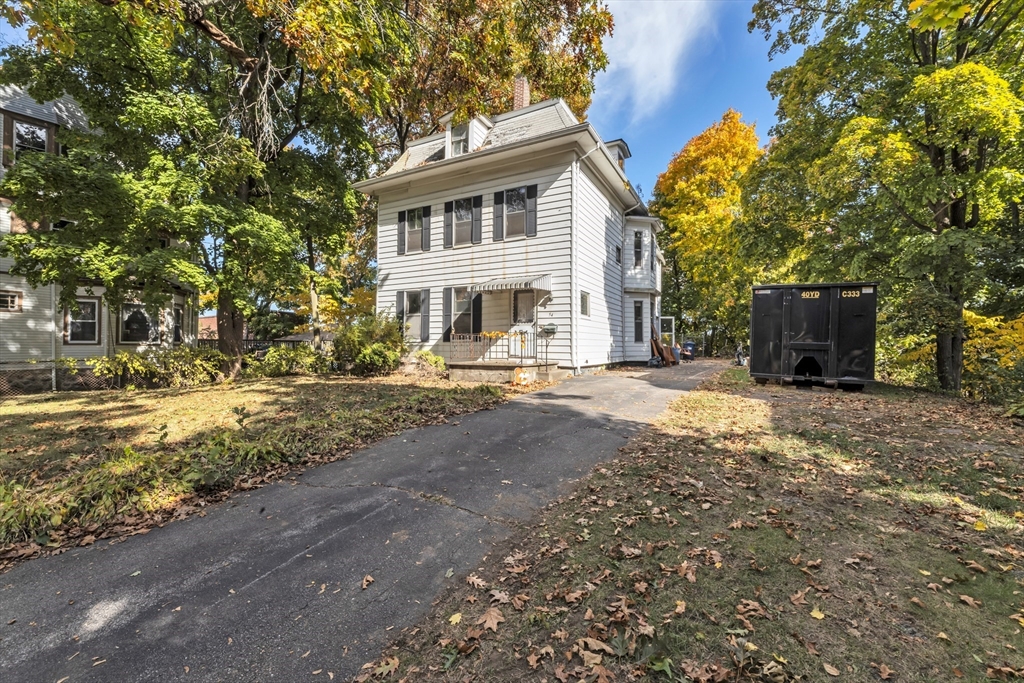54 Oak Street Boston, MA 02136 - Photo 5 of 13 a front view of a house with a yard and trees