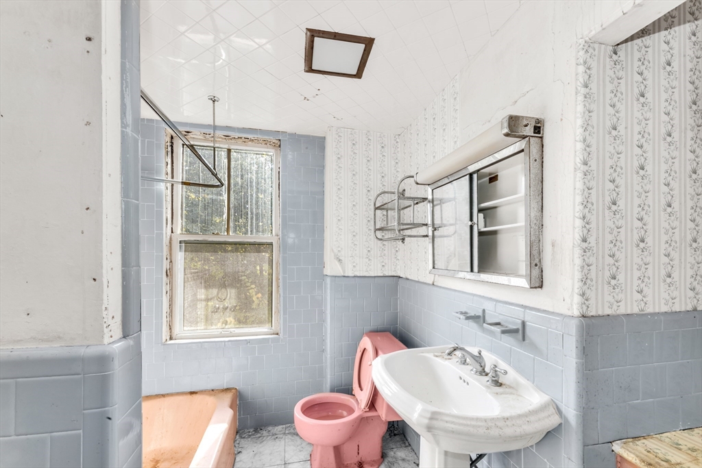 54 Oak Street Boston, MA 02136 - Photo 7 of 13 a bathroom with a sink mirror and toilet
