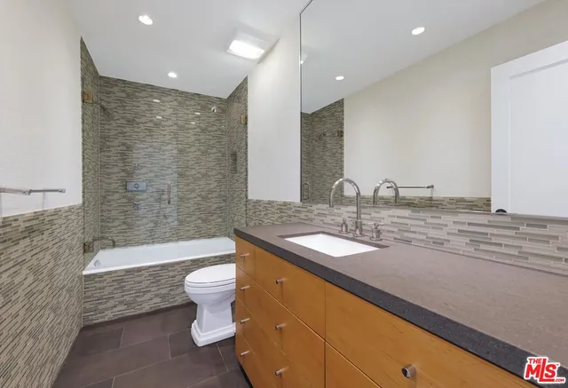 a bedroom with a bed and a potted plant