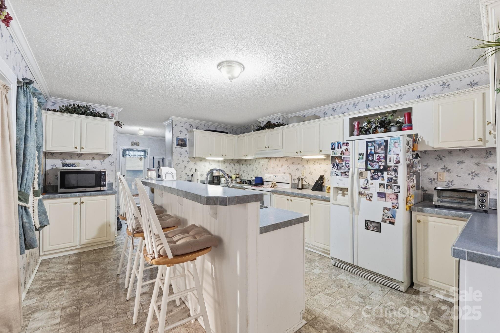 6351 Pleasant Grove Church Road Kannapolis, NC 28081 - Photo 11 of 24 a kitchen with white cabinets and stainless steel appliances