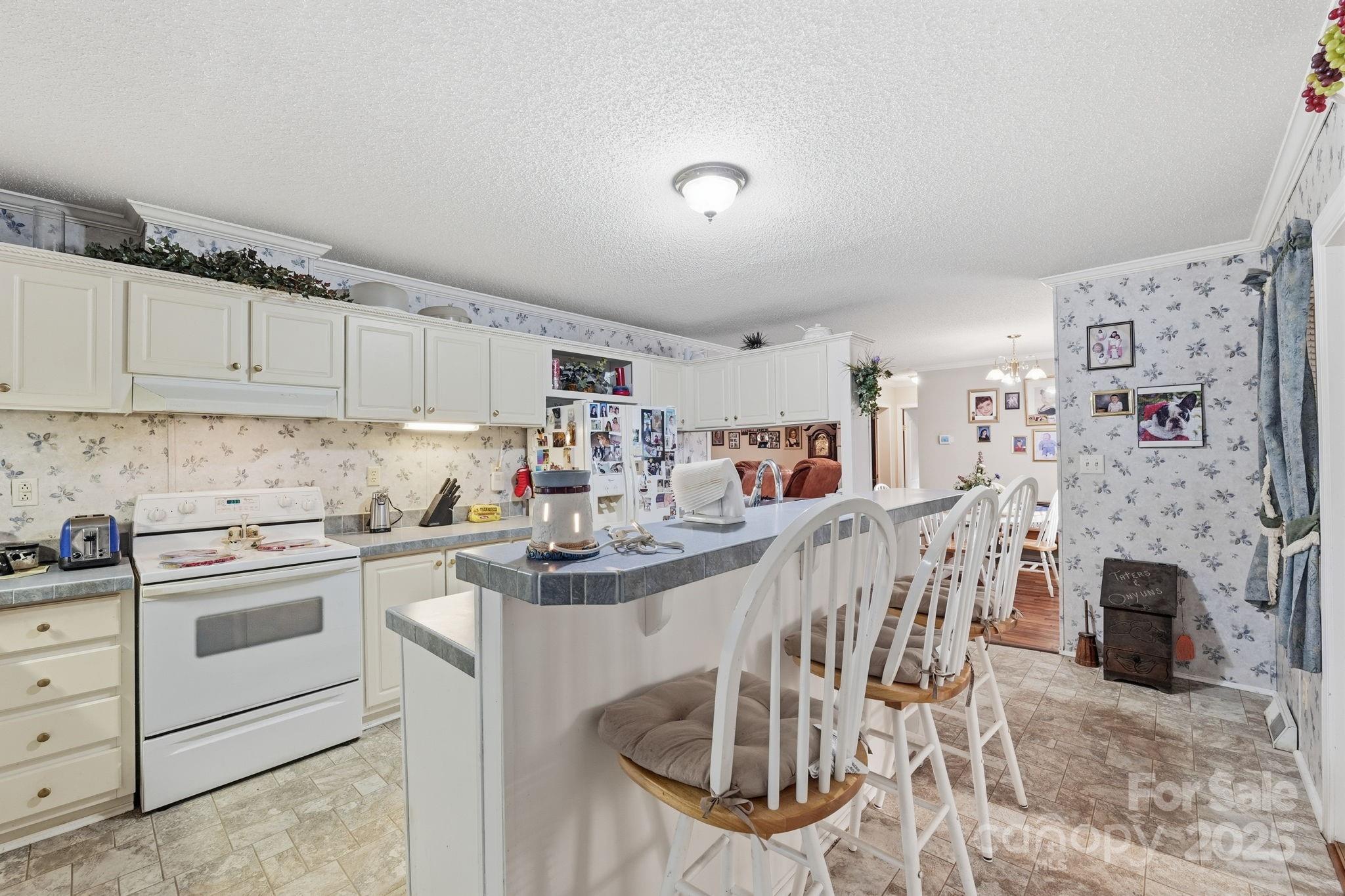 6351 Pleasant Grove Church Road Kannapolis, NC 28081 - Photo 12 of 24 a kitchen with cabinets and chairs