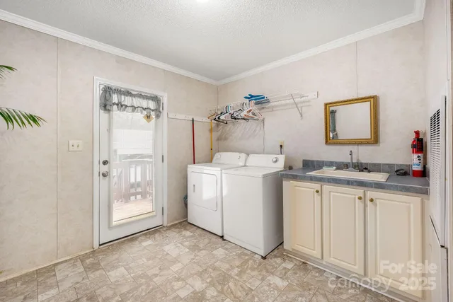 a view of cabinets a sink and a refrigerator in a room