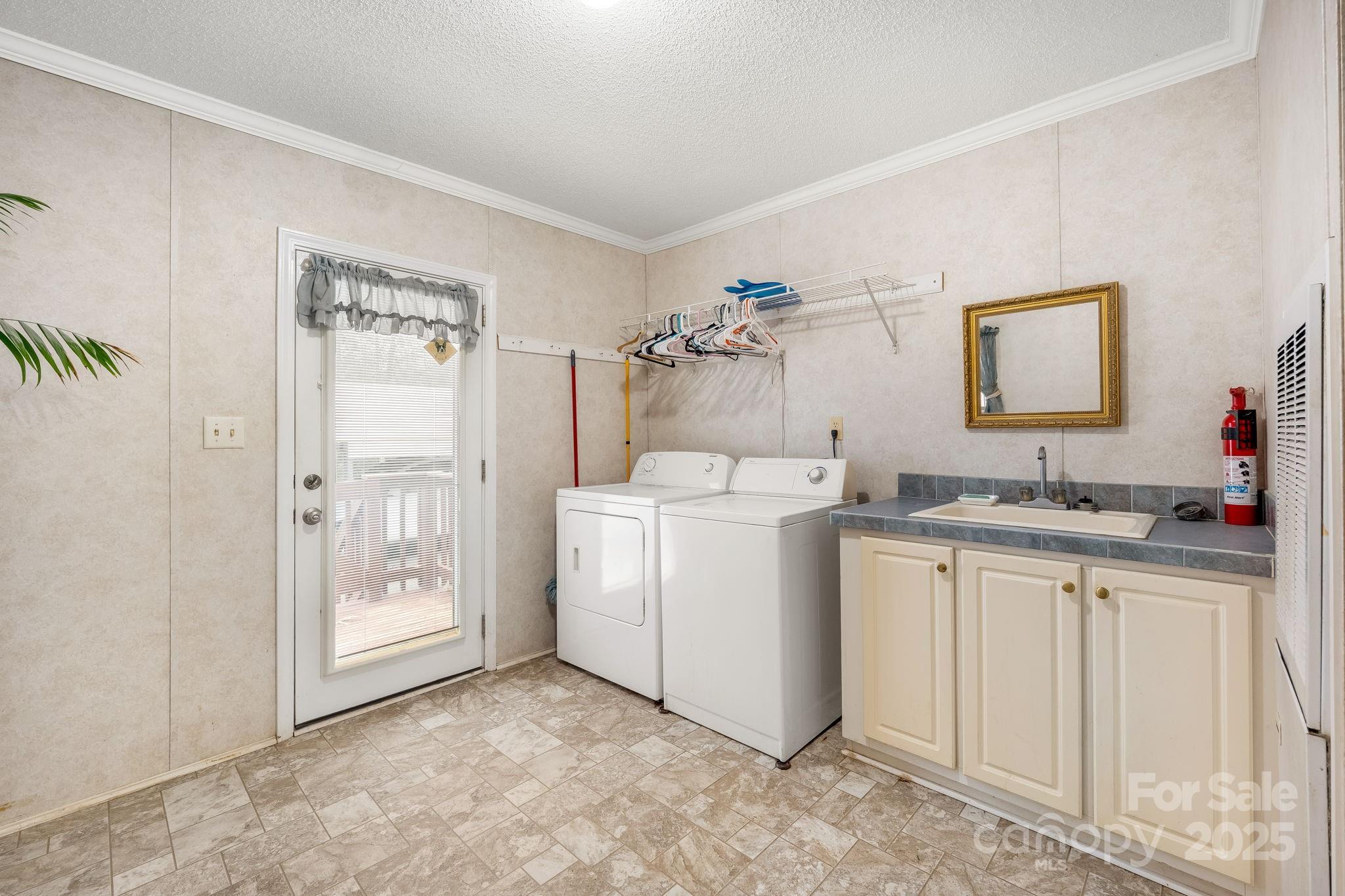 6351 Pleasant Grove Church Road Kannapolis, NC 28081 - Photo 17 of 21 a view of cabinets a sink and a refrigerator in a room