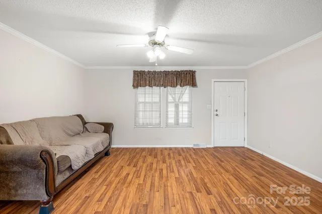 a living room with a bed furniture and a window