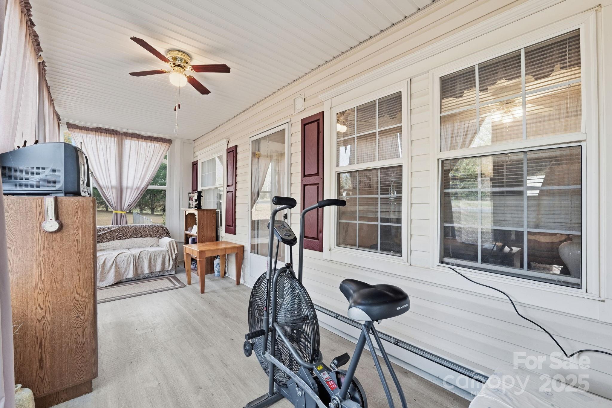 6351 Pleasant Grove Church Road Kannapolis, NC 28081 - Photo 5 of 24 a living room with furniture a flat screen tv and a large window