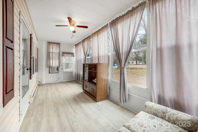 a hallway with a large window and refrigerator