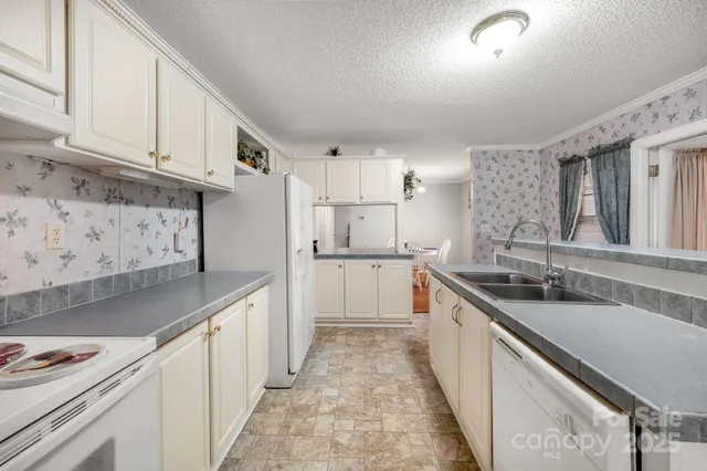 a kitchen with stainless steel appliances granite countertop a sink and cabinets