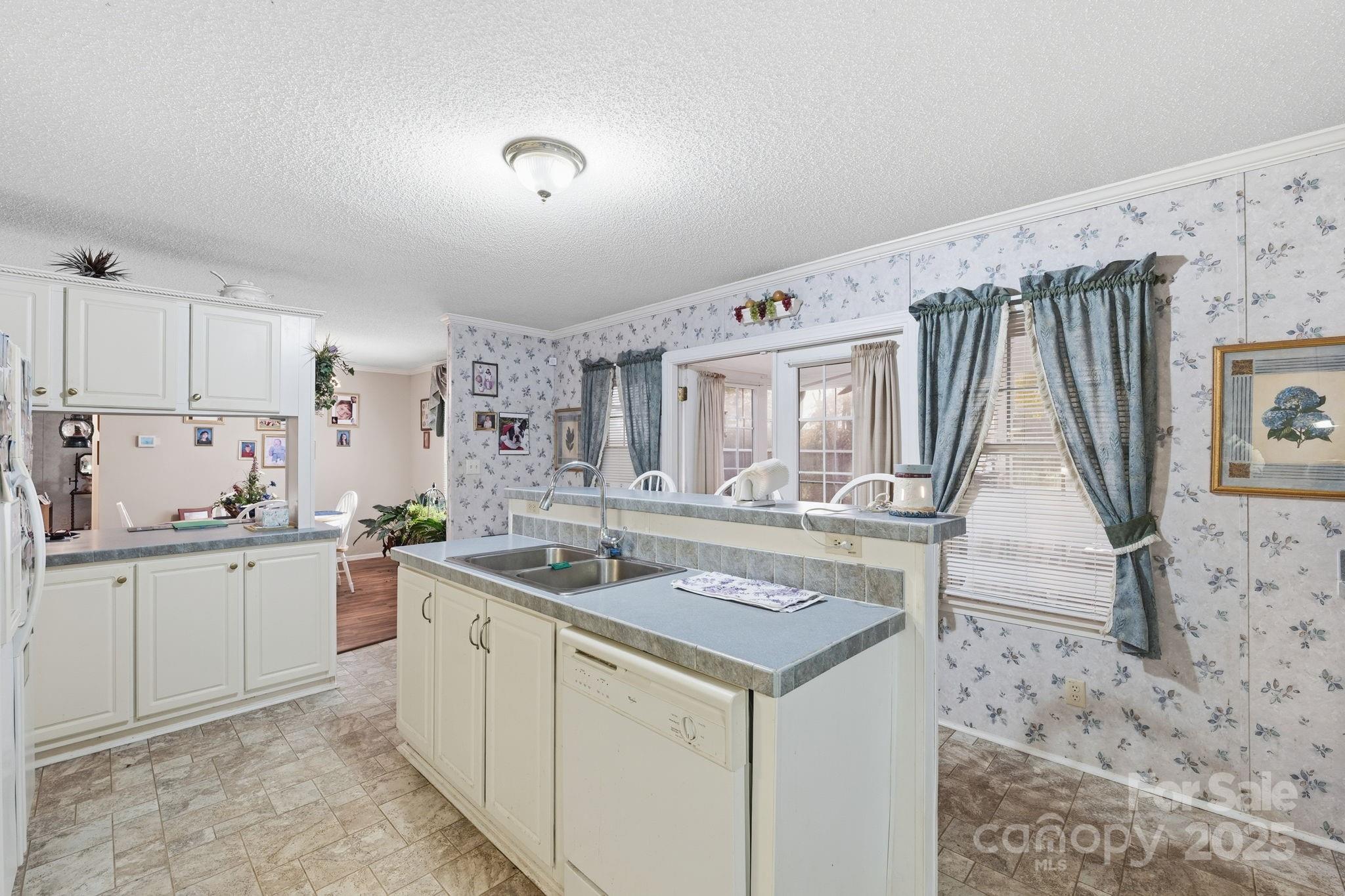 6351 Pleasant Grove Church Road Kannapolis, NC 28081 - Photo 10 of 24 a kitchen with a stove a sink and a refrigerator