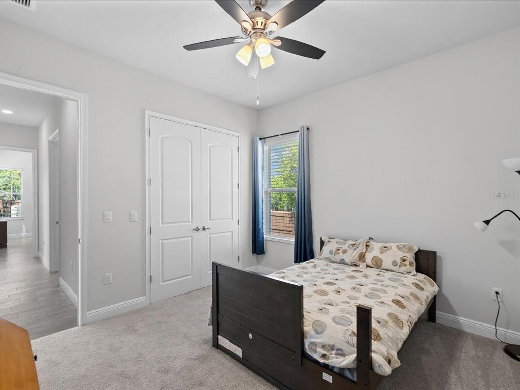 11981 Robina Road Weeki Wachee, FL 34614 - Photo 37 of 93 a room with a bed and a chandelier
