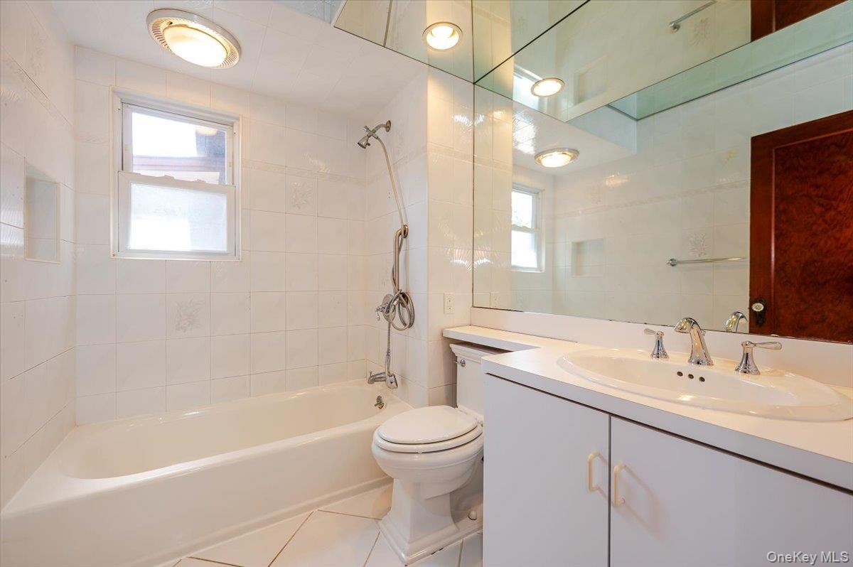 715 Iris Street Franklin Square, NY 11010 - Photo 11 of 20 a bathroom with a sink a toilet and shower