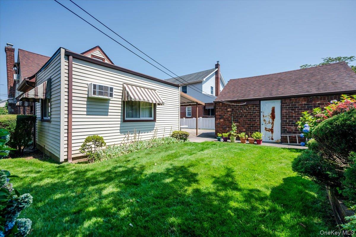 715 Iris Street Franklin Square, NY 11010 - Photo 19 of 20 a front view of a house with a garden