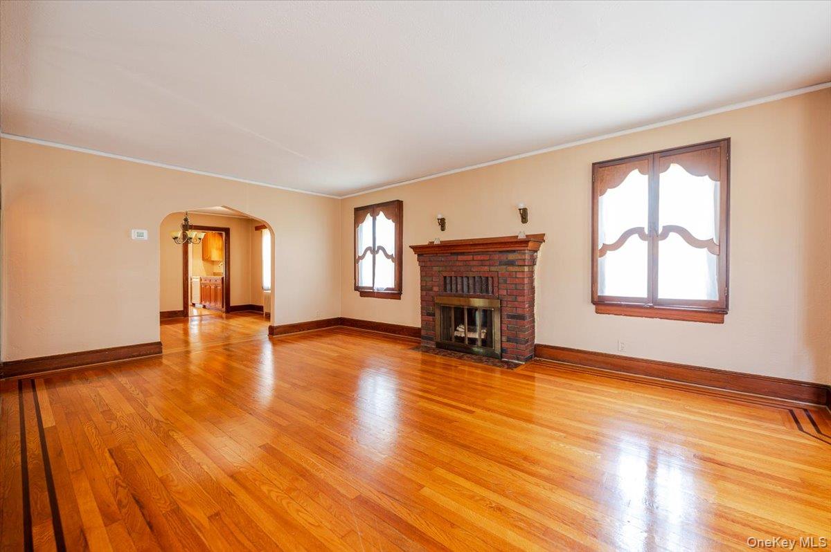 715 Iris Street Franklin Square, NY 11010 - Photo 4 of 20 a view of an empty room with window and wooden floor