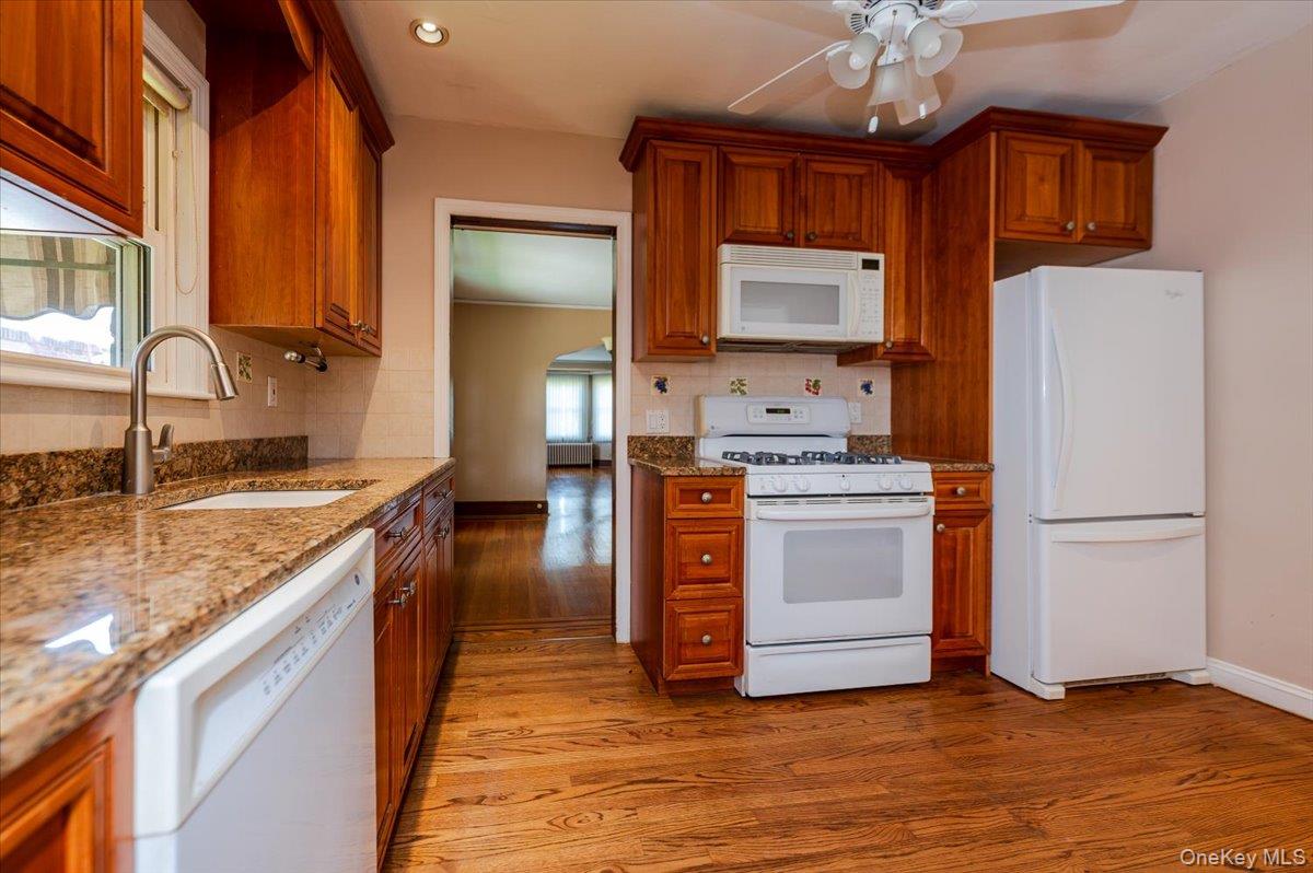 715 Iris Street Franklin Square, NY 11010 - Photo 6 of 20 a kitchen with stainless steel appliances granite countertop a sink stove and refrigerator