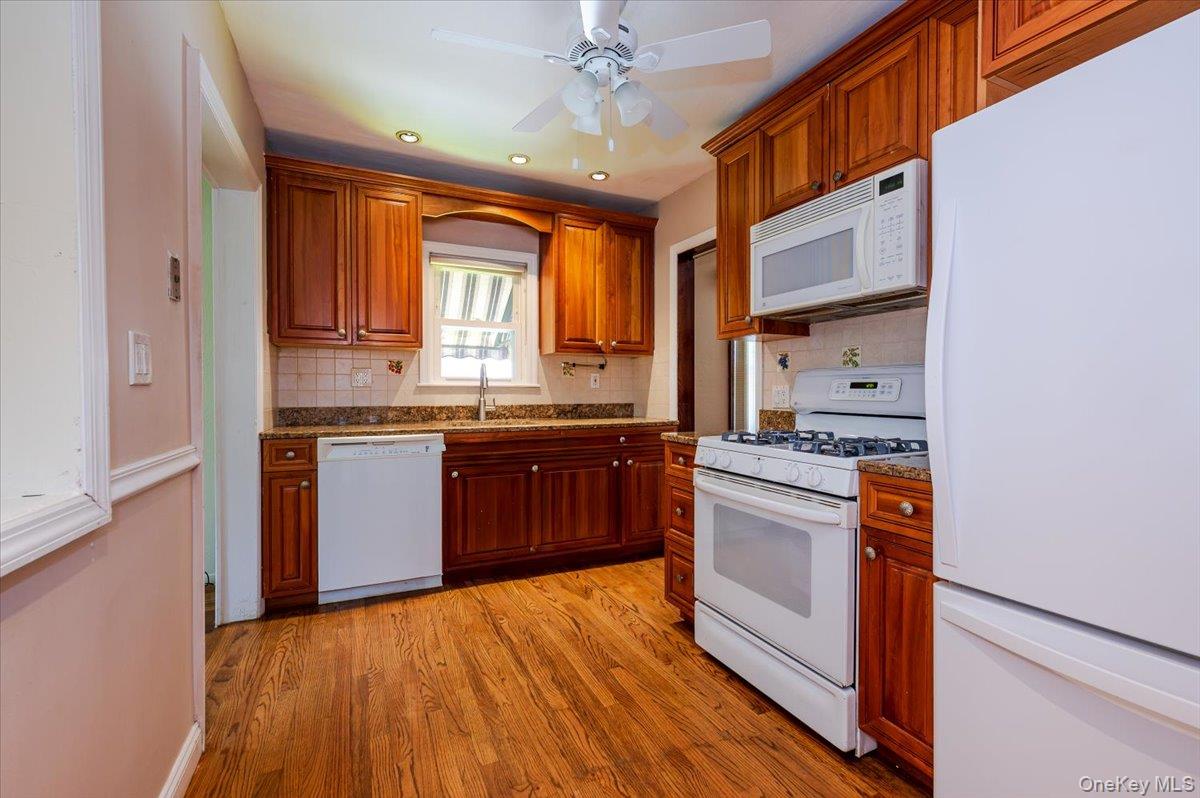 715 Iris Street Franklin Square, NY 11010 - Photo 7 of 20 a kitchen with stainless steel appliances granite countertop a stove cabinets and wooden floor