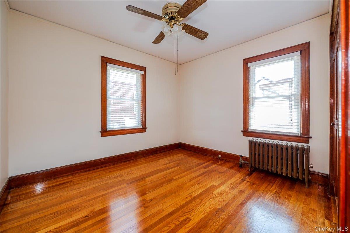 715 Iris Street Franklin Square, NY 11010 - Photo 8 of 20 a view of an empty room with window and wooden floor