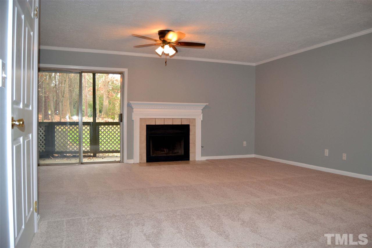 403 Broad Leaf Circle, Unit 403 Raleigh, NC 27613 - Photo 2 of 25 a view of an empty room with a fireplace