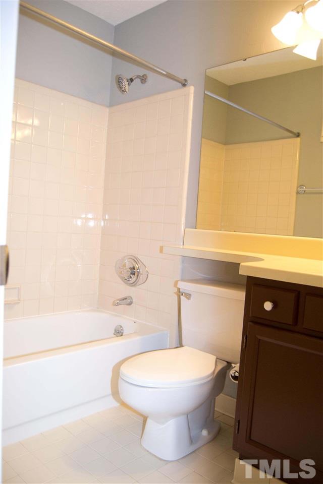 403 Broad Leaf Circle, Unit 403 Raleigh, NC 27613 - Photo 11 of 25 a bathroom with a toilet a sink and a bathtub