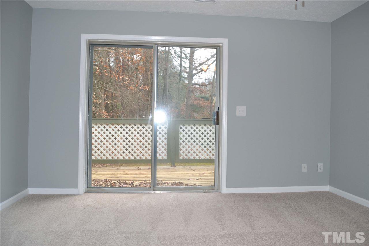 403 Broad Leaf Circle, Unit 403 Raleigh, NC 27613 - Photo 20 of 25 a view of empty room with wooden floor and sliding door