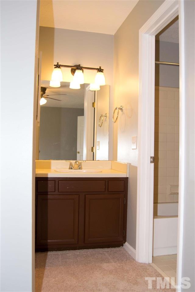 403 Broad Leaf Circle, Unit 403 Raleigh, NC 27613 - Photo 21 of 25 a bathroom with a sink and a mirror
