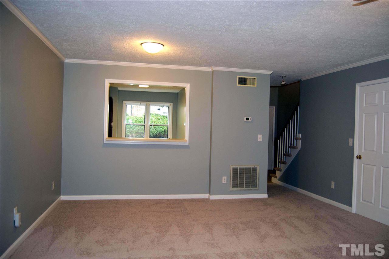 403 Broad Leaf Circle, Unit 403 Raleigh, NC 27613 - Photo 5 of 25 an empty room with windows and closet