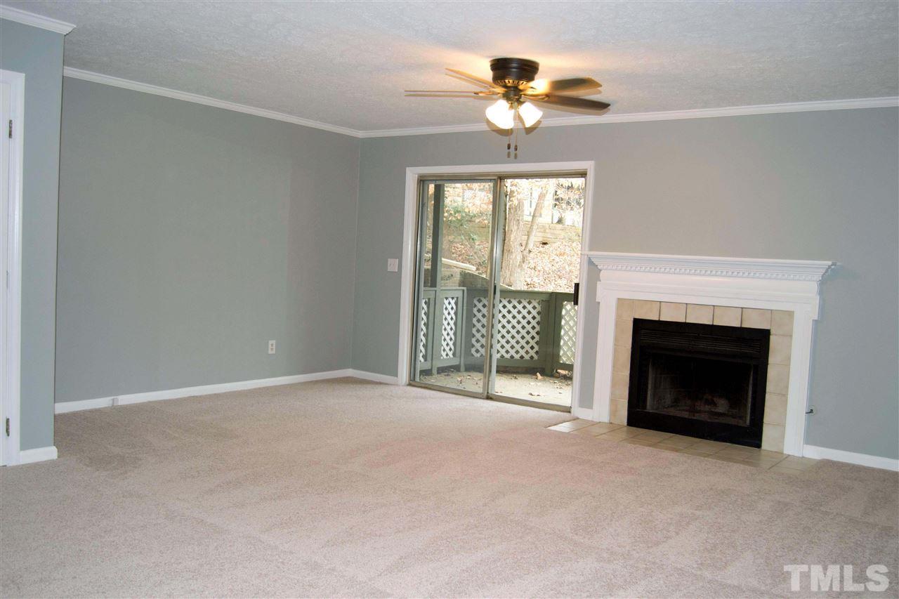 403 Broad Leaf Circle, Unit 403 Raleigh, NC 27613 - Photo 6 of 25 a view of an empty room with a fireplace and a window