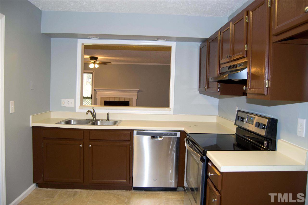 403 Broad Leaf Circle, Unit 403 Raleigh, NC 27613 - Photo 8 of 25 a kitchen with a sink and a stove top oven with wooden floor
