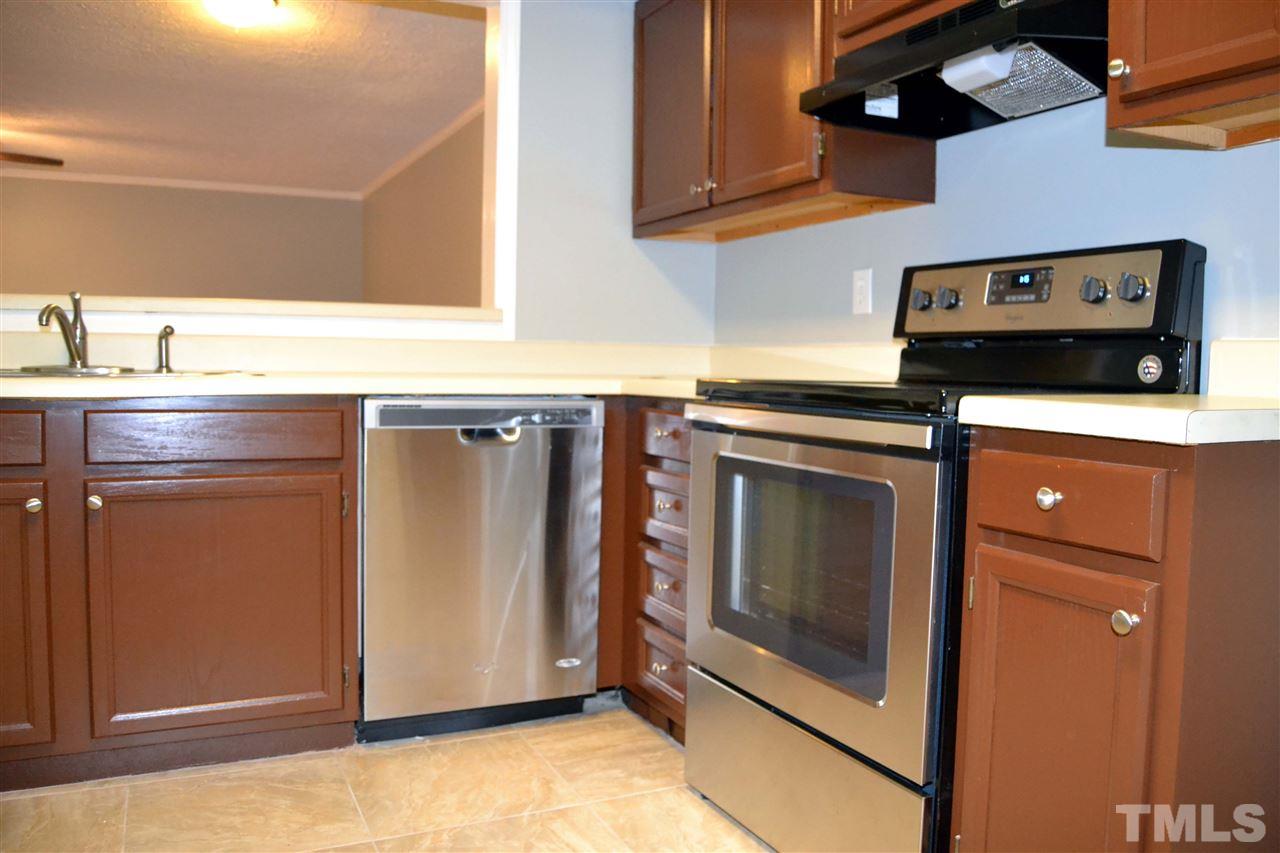 403 Broad Leaf Circle, Unit 403 Raleigh, NC 27613 - Photo 9 of 25 a kitchen with stainless steel appliances granite countertop a stove and a microwave