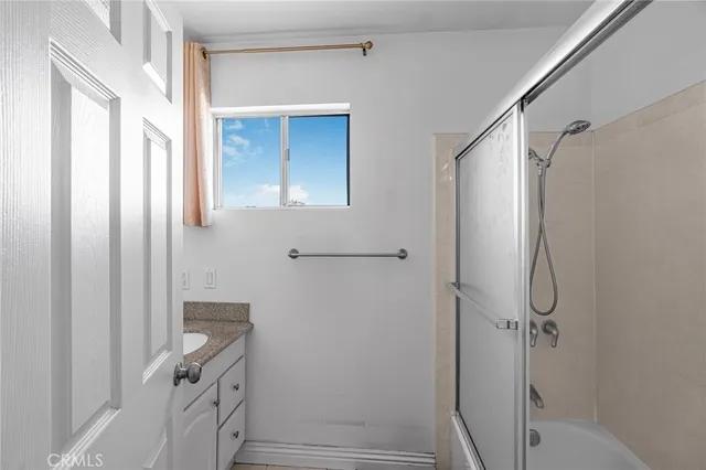 a bathroom with a shower and a sink