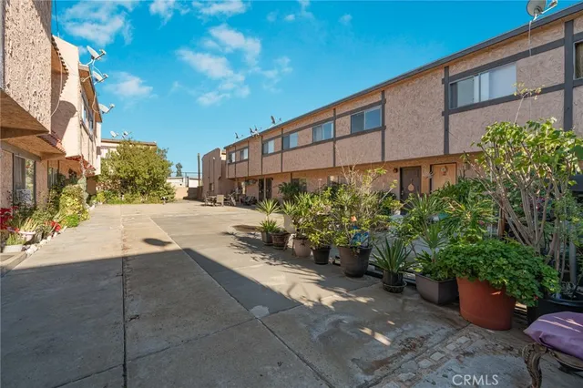 a view of a street with potted plants