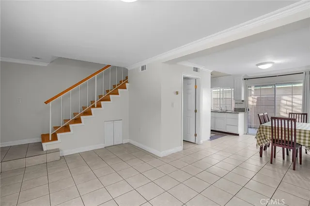 a view of a livingroom with furniture and staircase