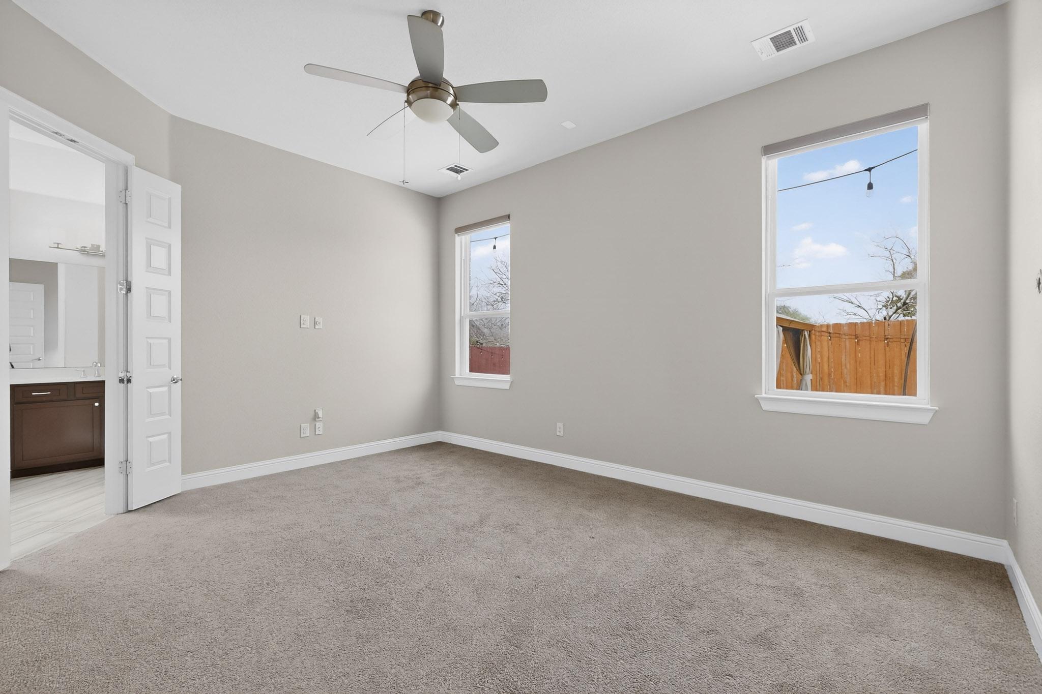 3137 Catalina Ranch Road Leander, TX 78641 - Photo 8 of 21 Unfurnished bedroom with light carpet, ceiling fan, and ensuite bath