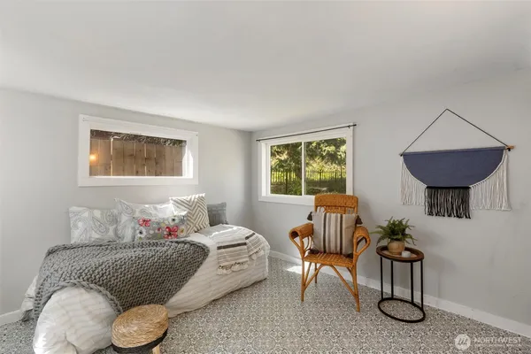a bedroom with furniture and a window