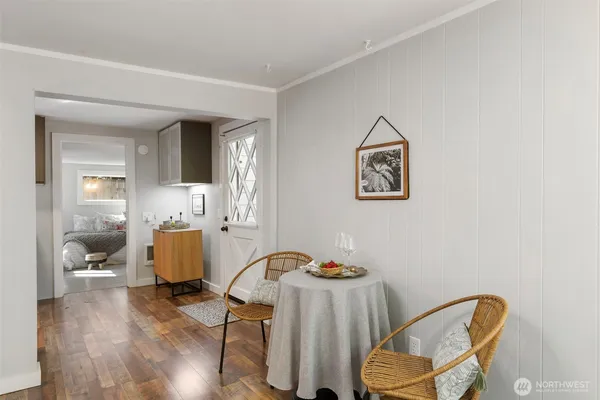 a view of a workspace with furniture and wooden floor