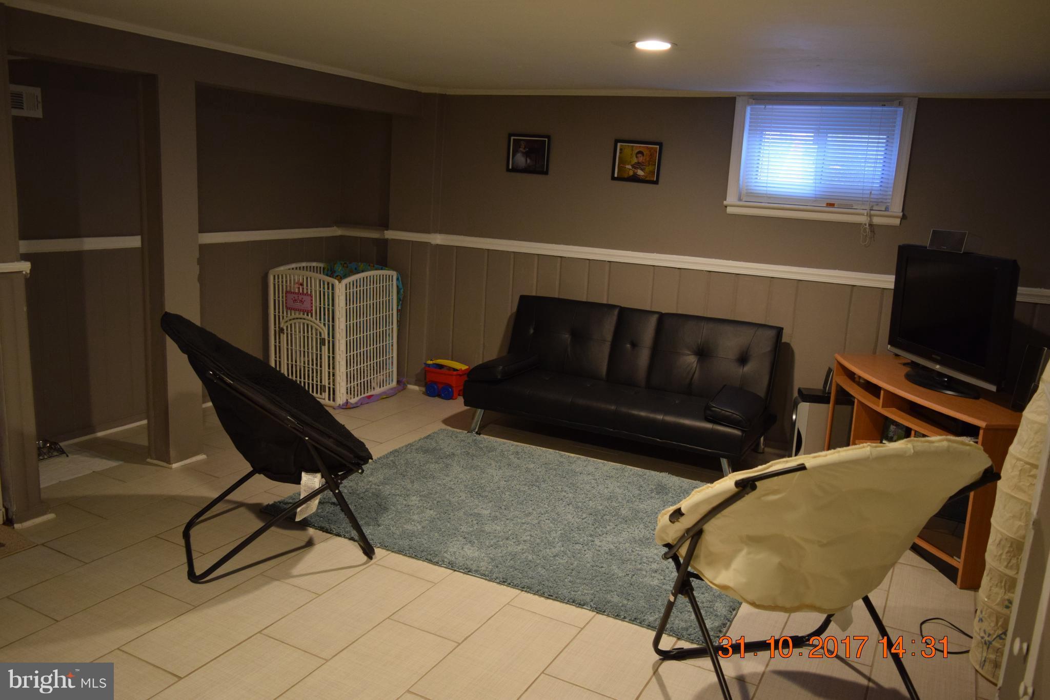 12046 Claridge Road Silver Spring, MD 20902 - Photo 14 of 16 a living room with chairs and a chair