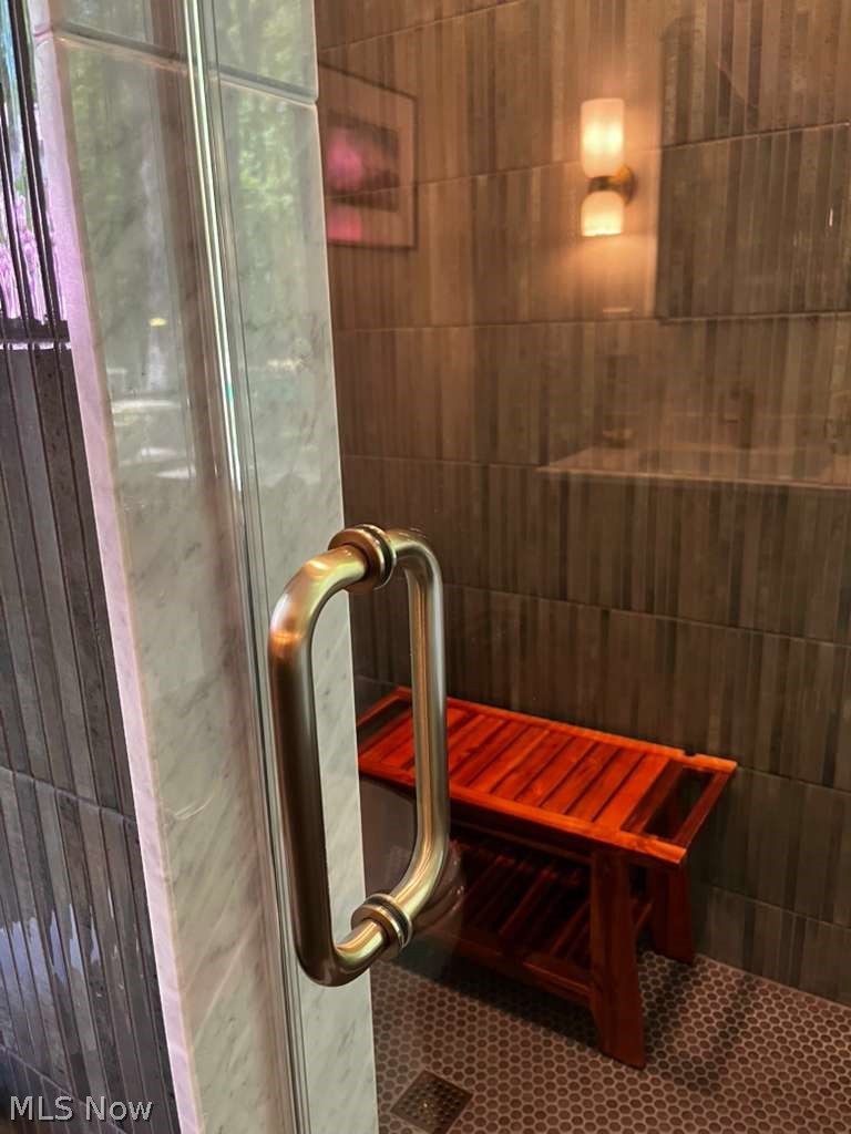 31599 Fairview Road Chagrin Falls, OH 44022 - Photo 29 of 50 Luxurious glass-enclosed steam shower with full-height glass panels and a brushed-metal handle for a sleek, modern look.