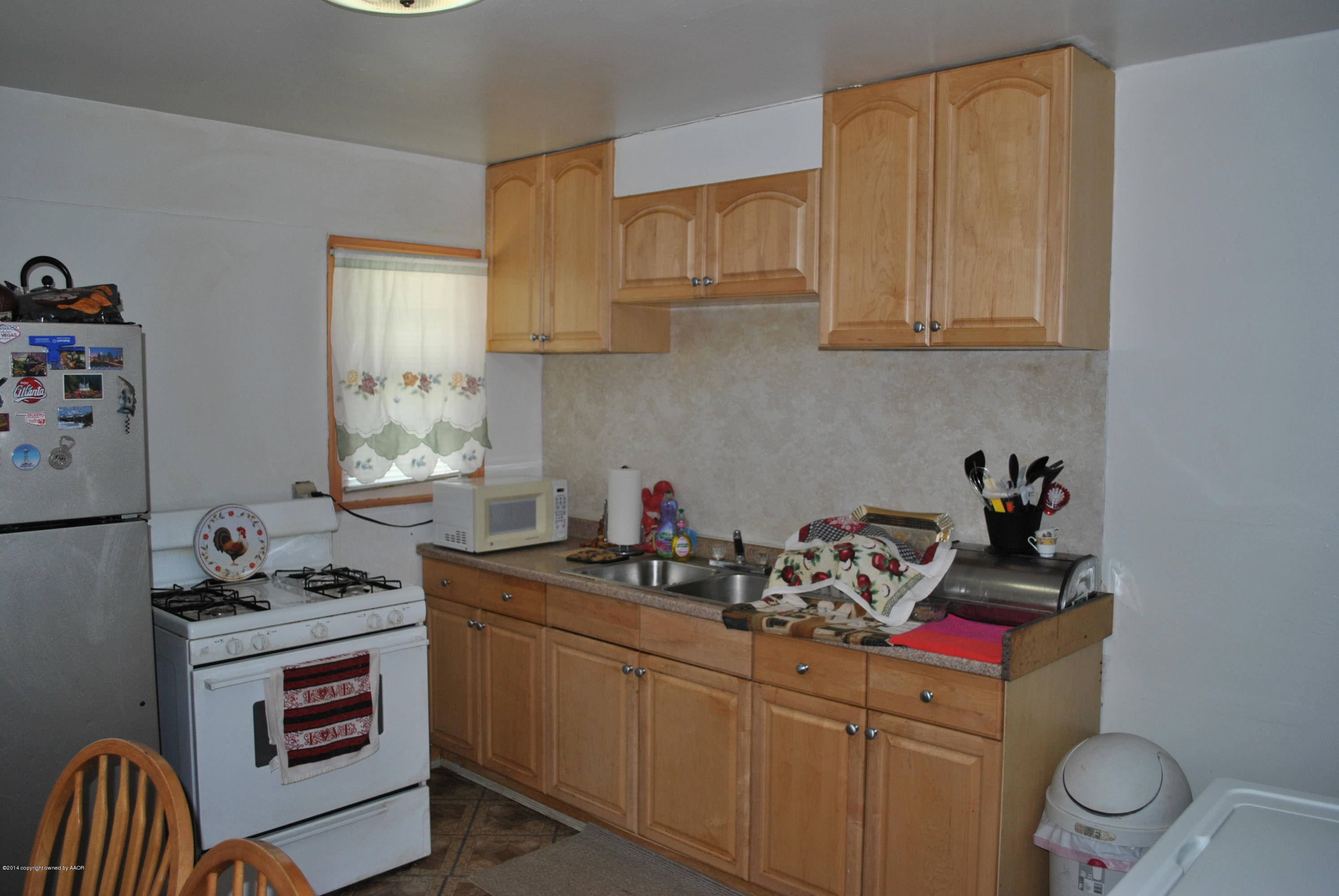 4625 Cline Road Amarillo, TX 79110 - Photo 11 of 16 a kitchen with stainless steel appliances a stove a sink and cabinets