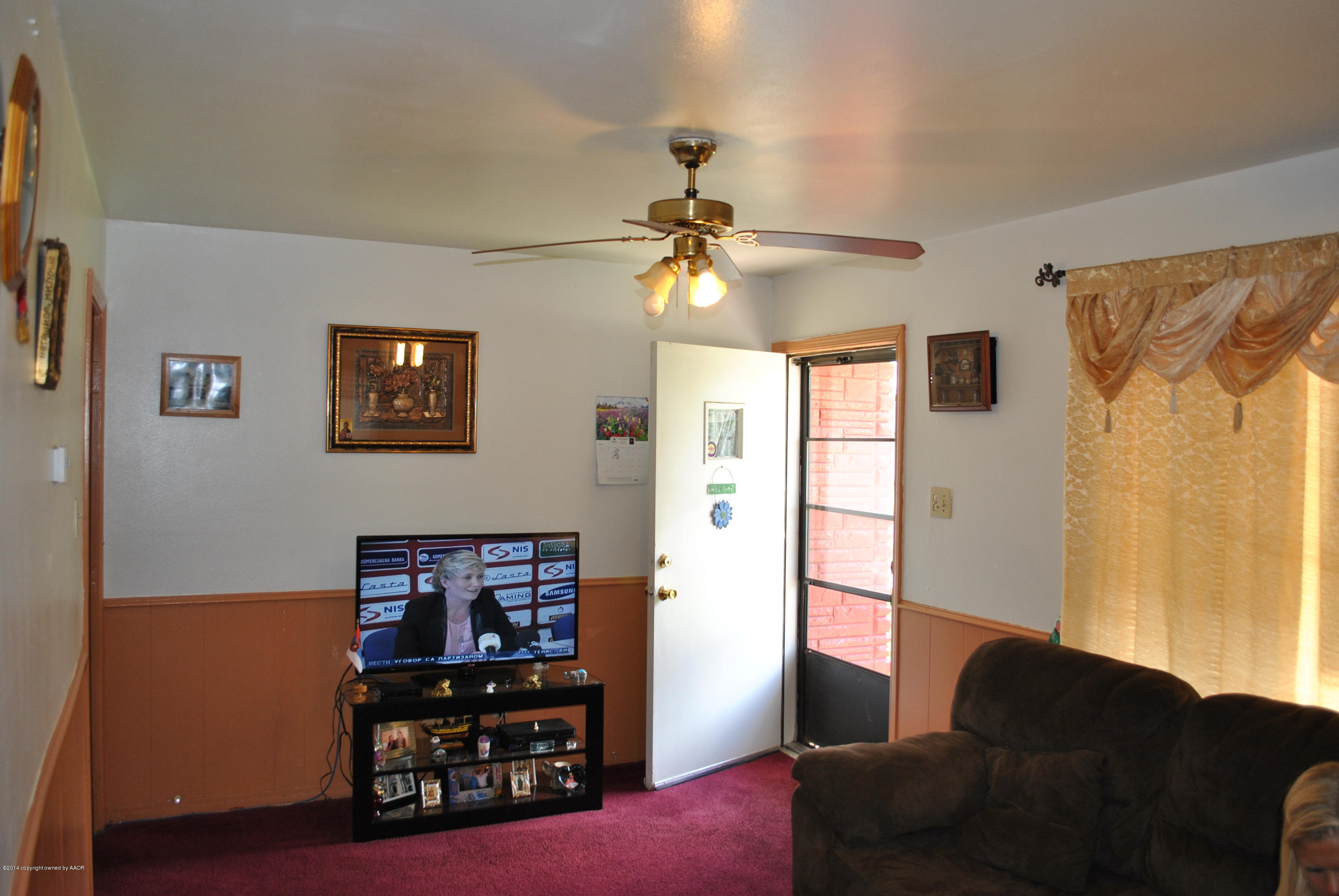 4625 Cline Road Amarillo, TX 79110 - Photo 12 of 16 a living room with furniture a lamp and a window