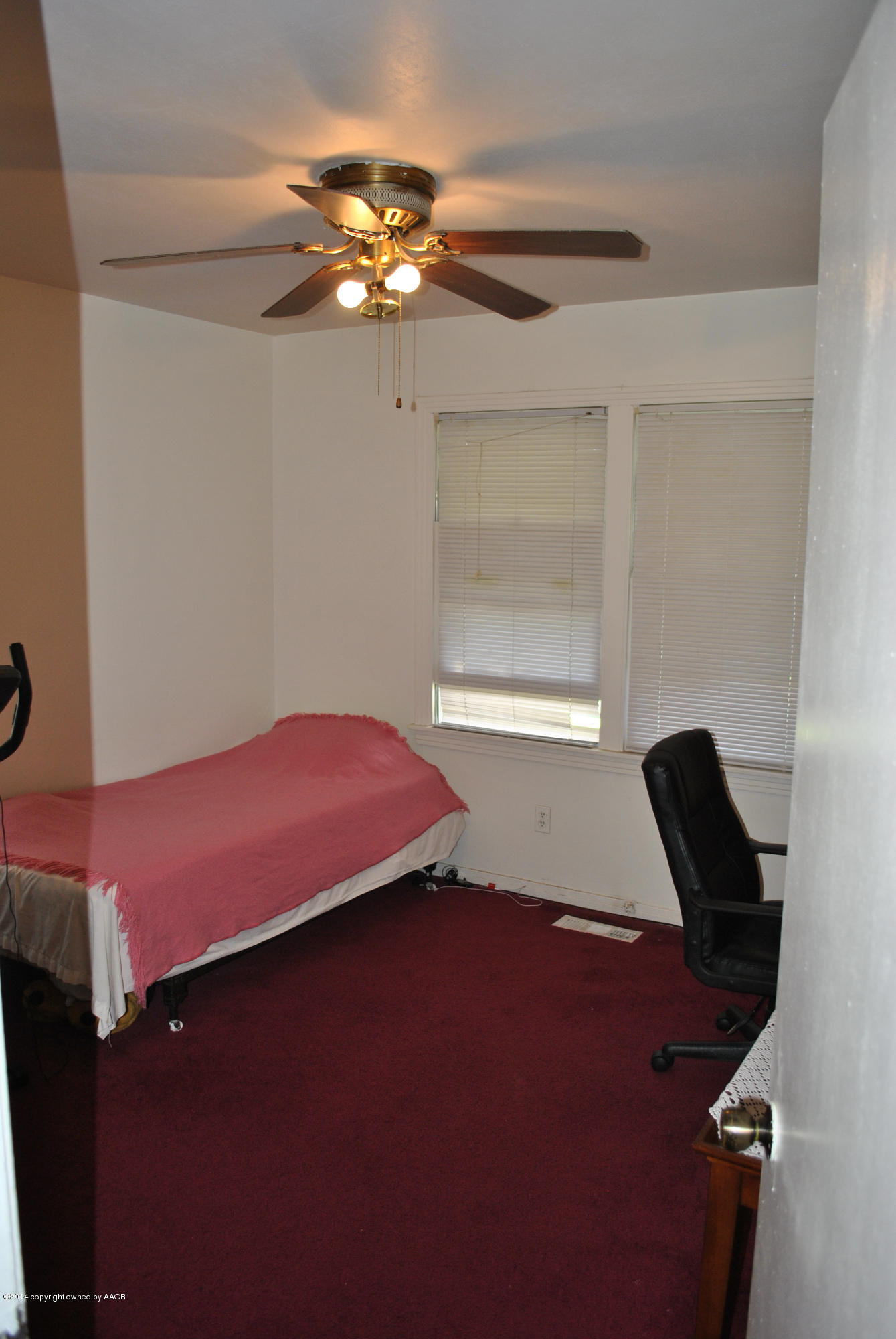 4625 Cline Road Amarillo, TX 79110 - Photo 7 of 16 a bedroom with a bed and a chandelier
