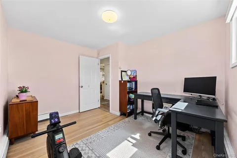 a view of a workspace with furniture and wooden floor