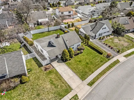 an aerial view of a house with a garden and swimming pool