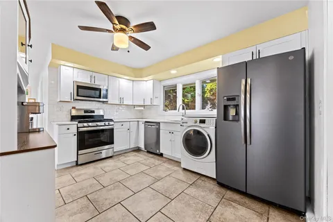 a kitchen with a refrigerator sink and stove