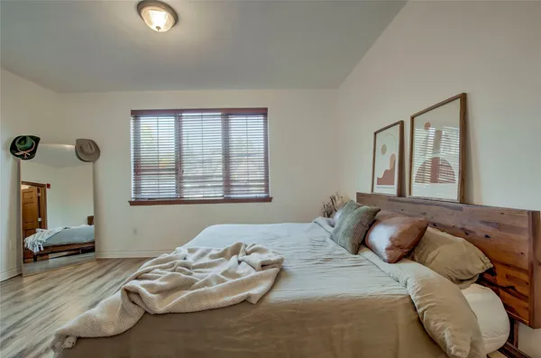 a bedroom with bed and a window