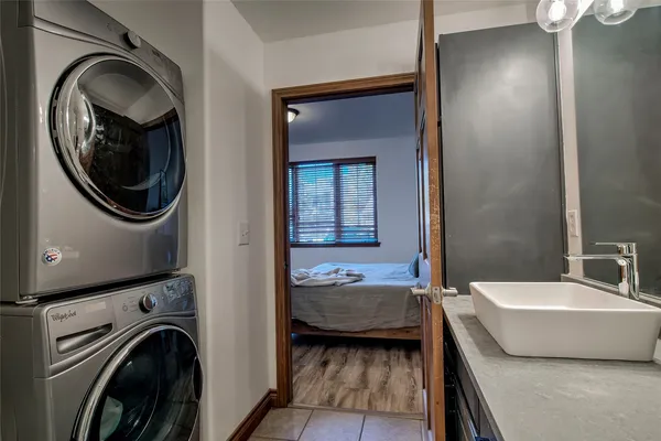 a en suite bathroom with a granite countertop sink and a mirror