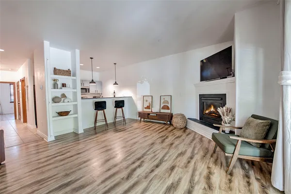 a living room with furniture a flat screen tv and a fireplace