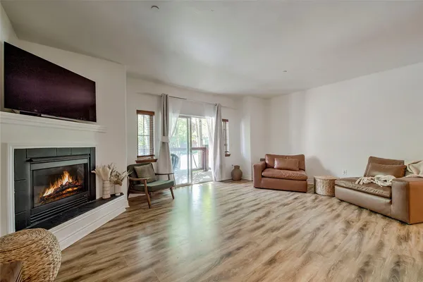 a living room with furniture flat screen tv and a fireplace