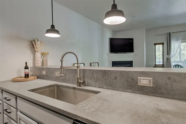 a kitchen with a sink and a chandelier