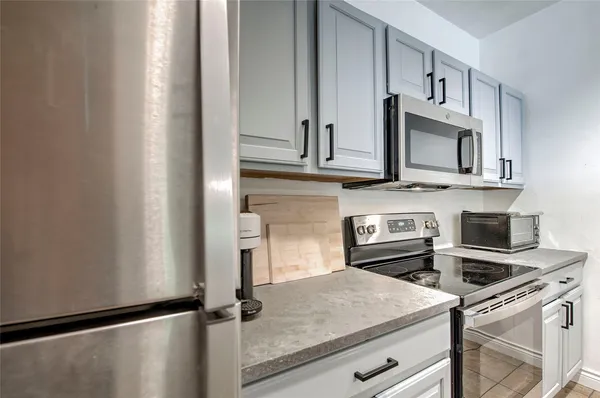 a kitchen with stainless steel appliances granite countertop a refrigerator sink and stove