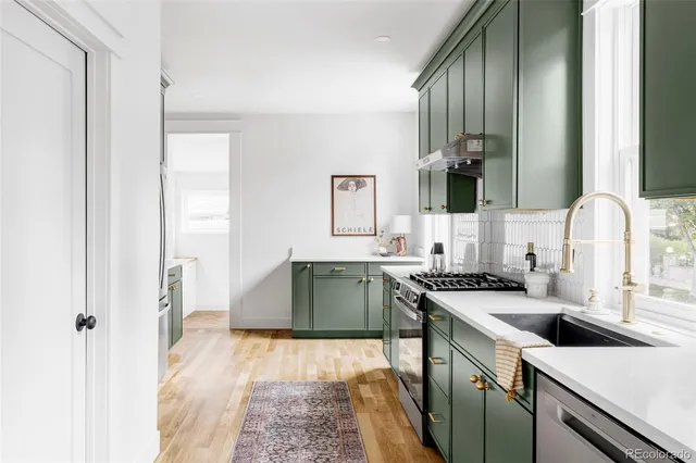 a kitchen with a sink stove and cabinets