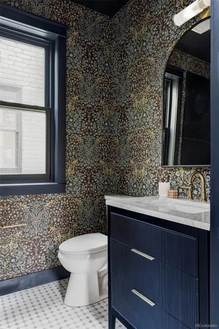 a bathroom with a toilet sink and mirror