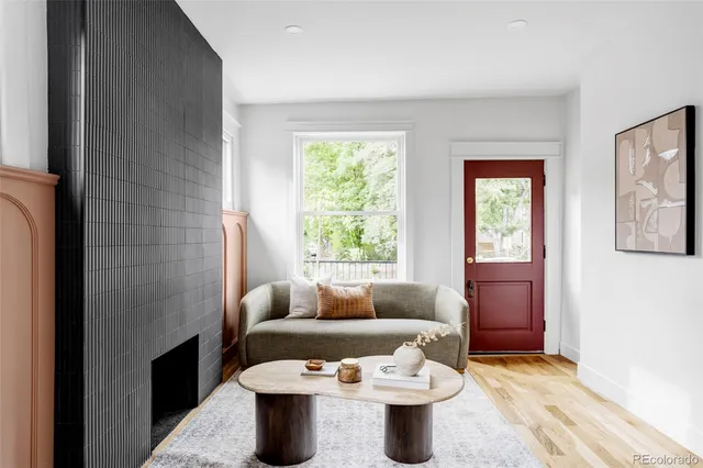 a living room with furniture a window and a fireplace